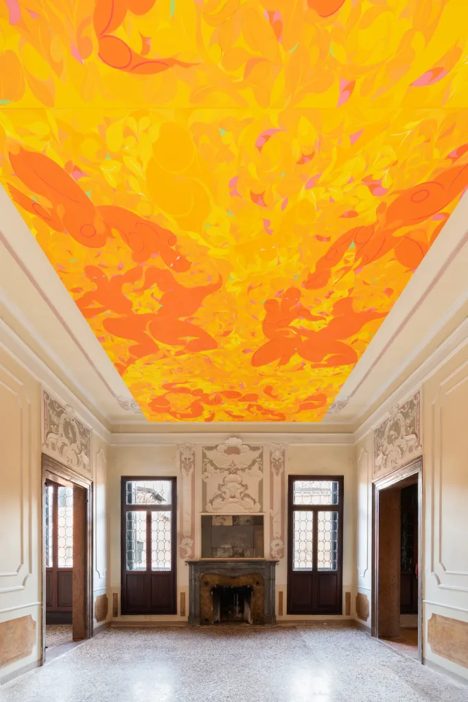 A room featuring a ceiling adorned with an intricate orange design