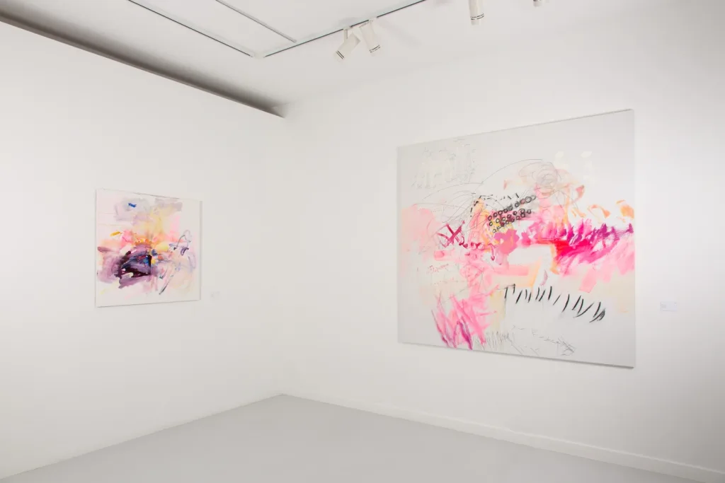Gallery with two abstract paintings. Left: pastel colors with dynamic strokes. Right: larger, vivid pinks and intricate patterns, conveying energy.